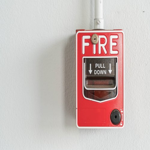 Fire alarm switch on white wall